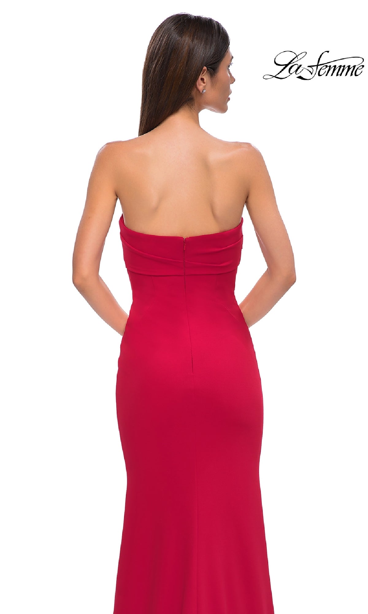 A woman is seen from the back wearing the Strapless Sweetheart Prom Gown: La Femme 32863, a long strapless dress with a sweetheart neckline, set against a plain white background with the